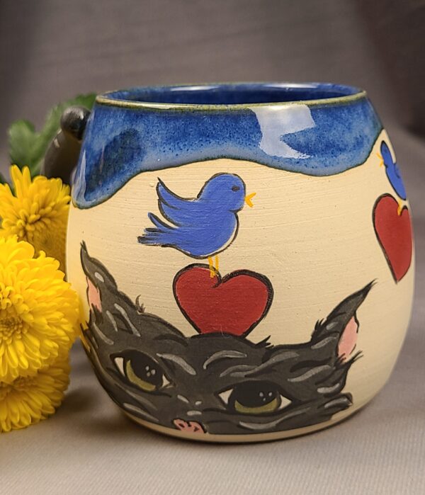 Blue mug with illustration of cat and birds
