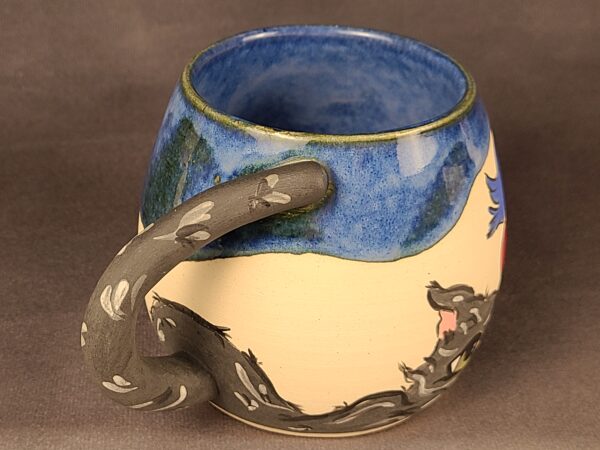 Blue mug with illustration of cat and birds