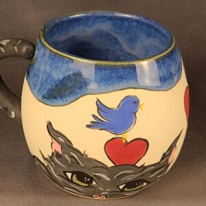 Blue mug with illustration of cat and birds