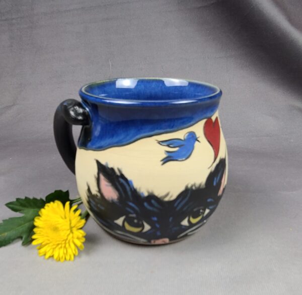 Blue and tan mug with cat illustration