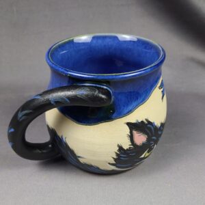 Blue and tan mug with cat illustration