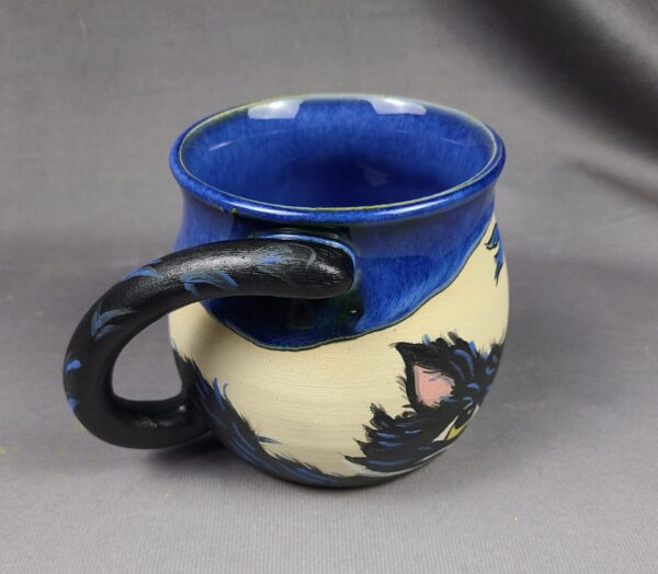Blue and tan mug with cat illustration